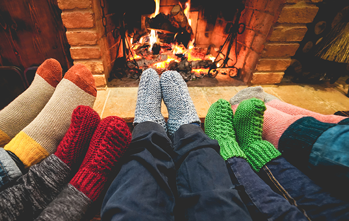 family wearing fuzzy socks in front of their fireplace in their new home mortgaged with greylock