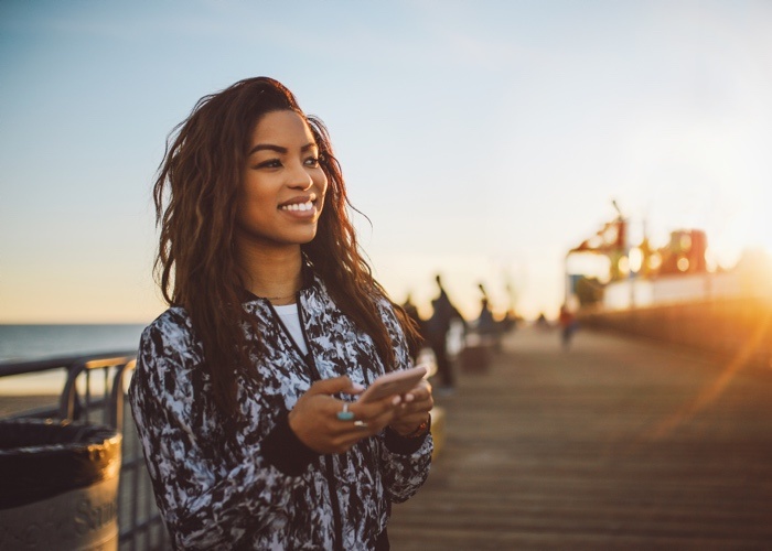 girl using mobile phone to access greylock mobile banking