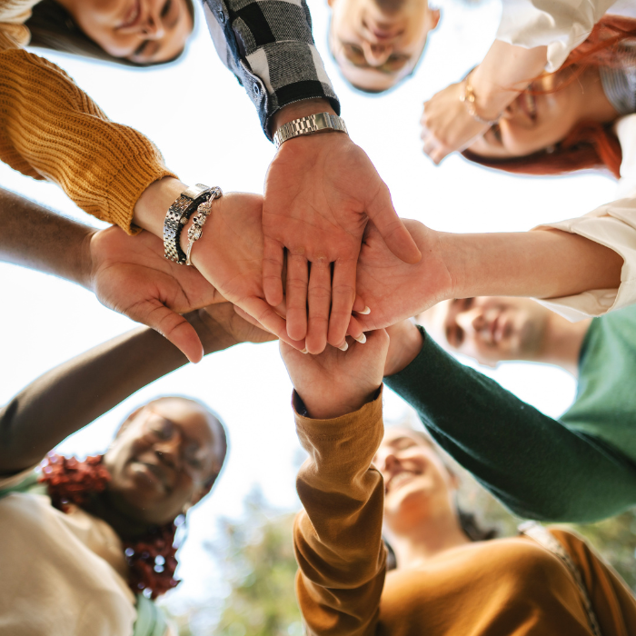 a group of people with their hands together