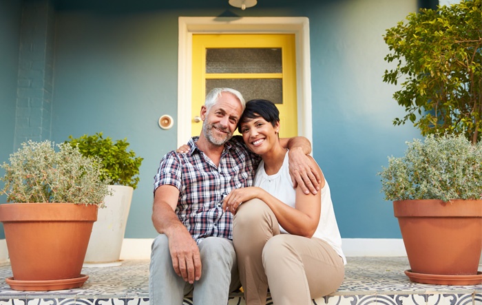 home owners sitting on front steps with mortgage from greylock federal credit union