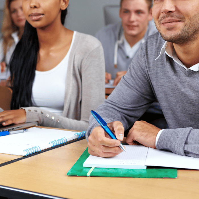 people taking notes in a class